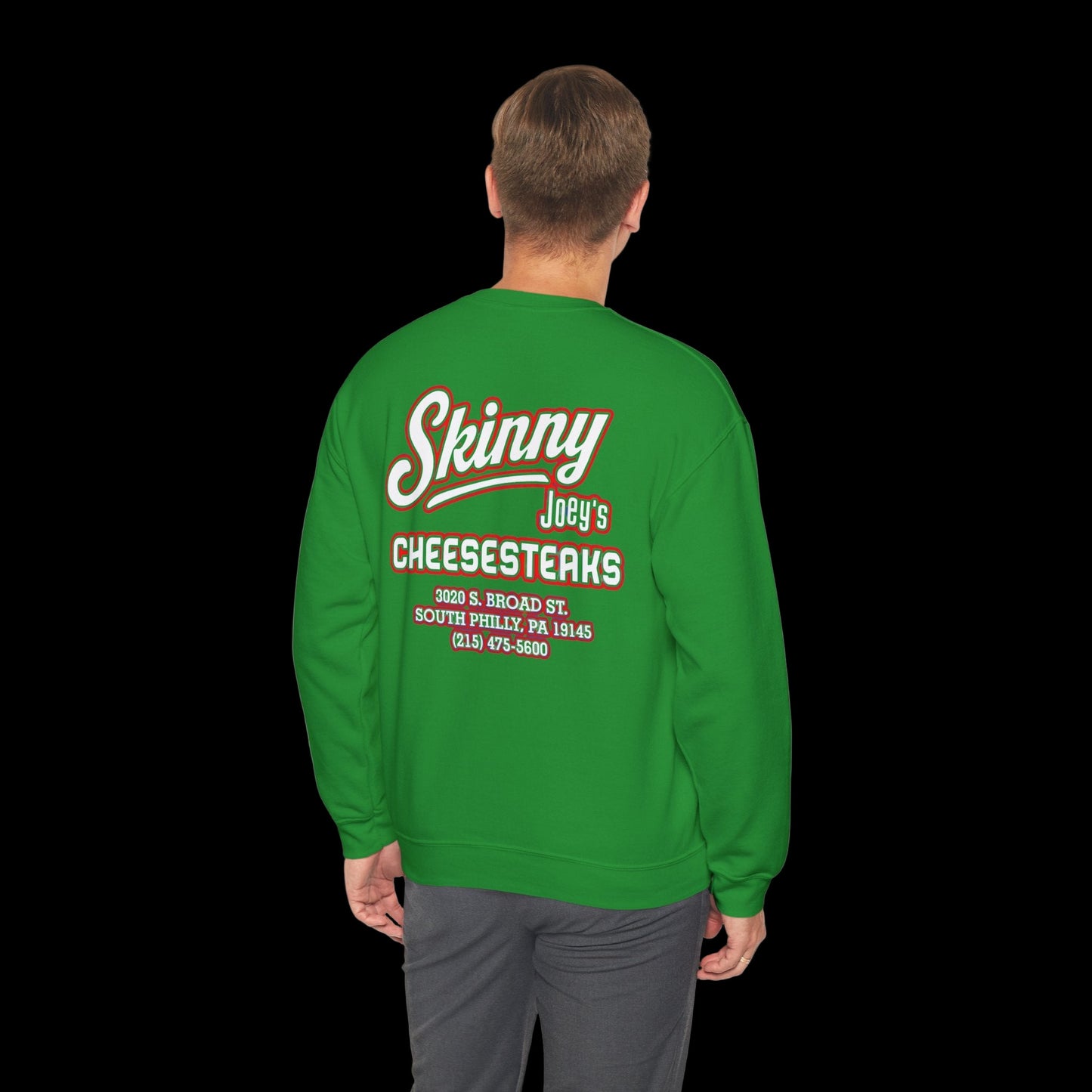 Green sweatshirt with 'Skinny Joey's Cheesesteaks' text on the back, worn by a person.