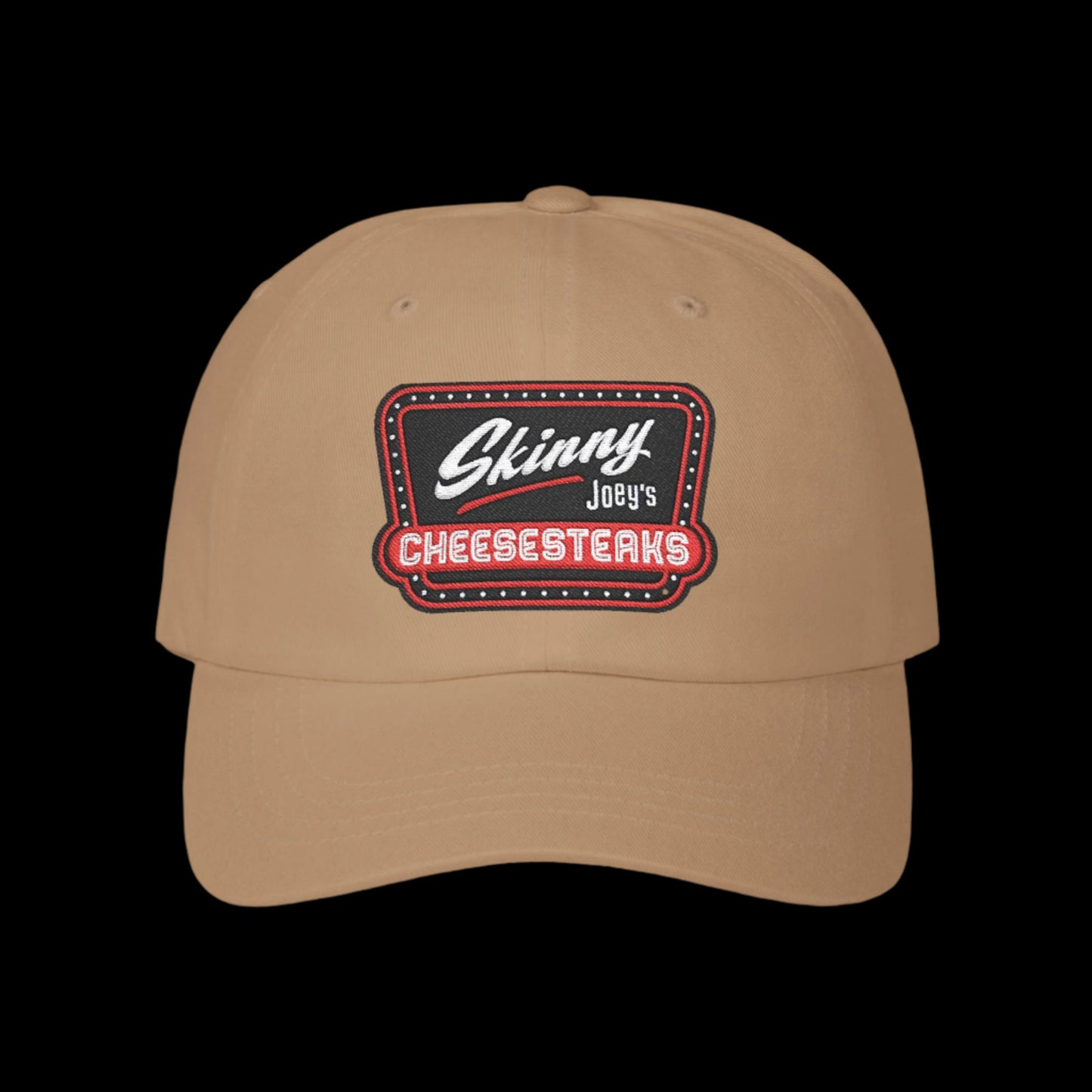 Beige cap with 'Skinny Joey's Cheesesteaks' logo on a white background.Skinny Joey Merlino hat, Skinny Joey merch, Joey Merlino hat, Philly cheesesteak hat, Skinny Joey’s Cheesesteaks streetwear, Joey Merlino apparel, The Skinny Podcast hat, mob-inspired fashion, South Philly cap, Skinny Joey red logo hat.