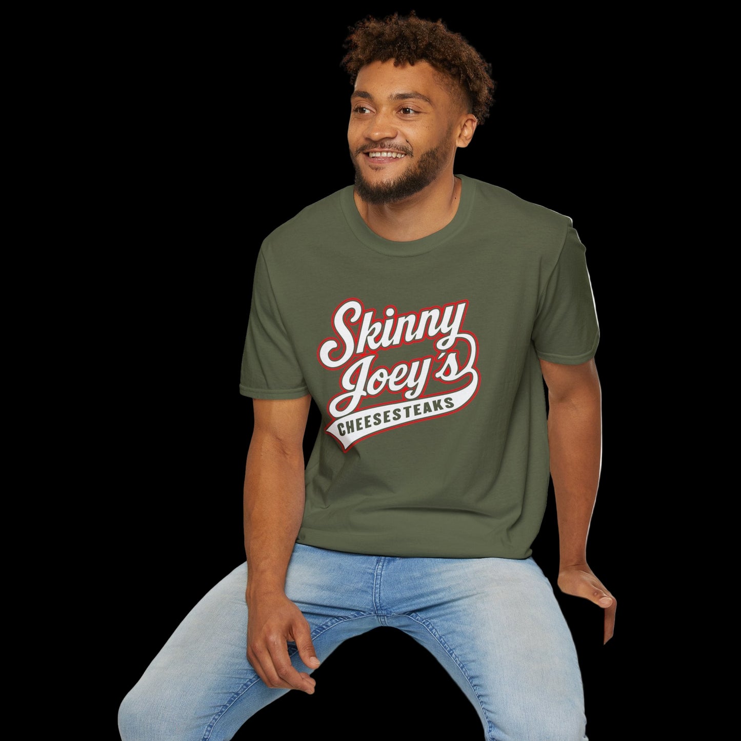 Man wearing a green t-shirt with 'Skinny Joey's Cheesesteaks' text, sitting on a white stool against a white background.