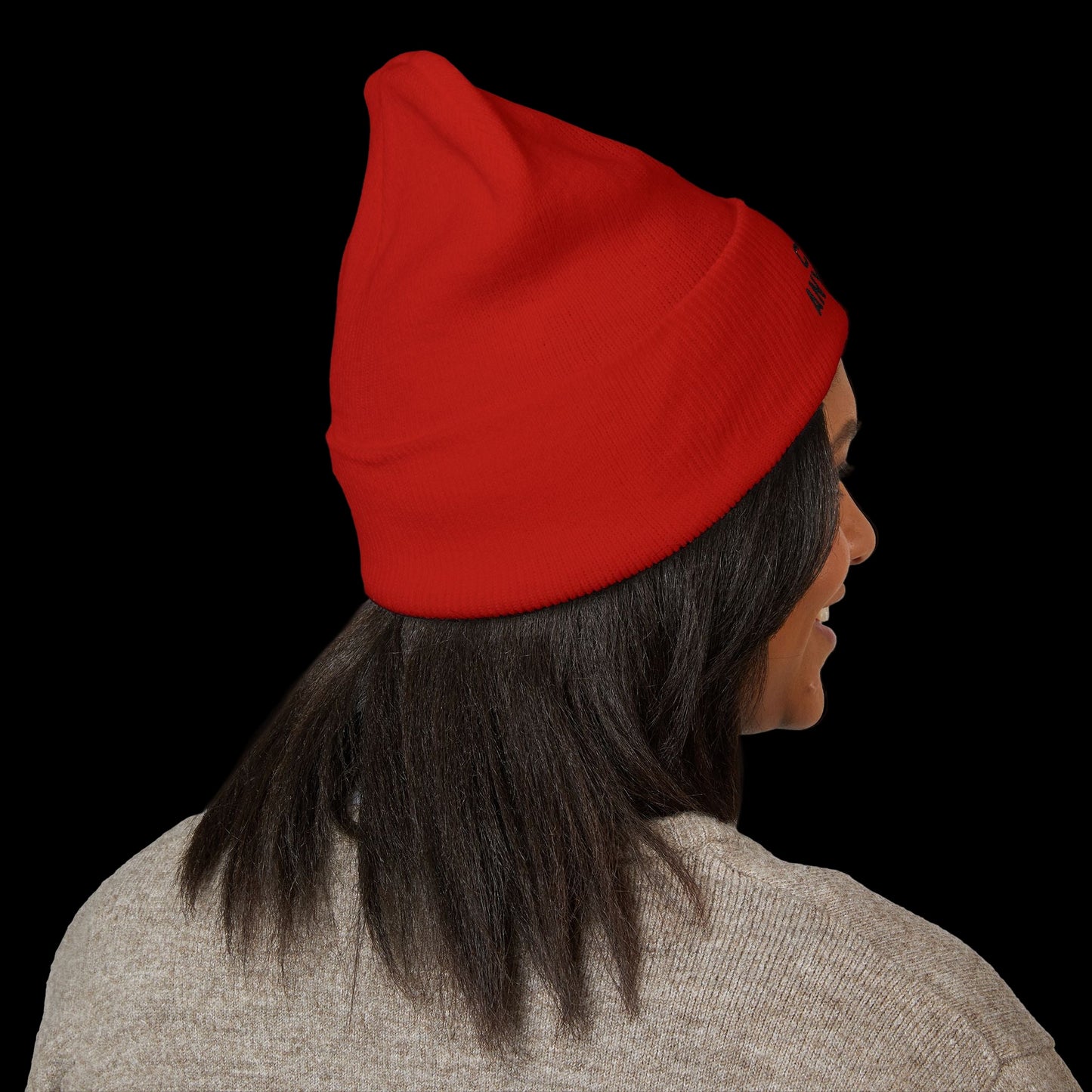 Person wearing a red beanie on a black background