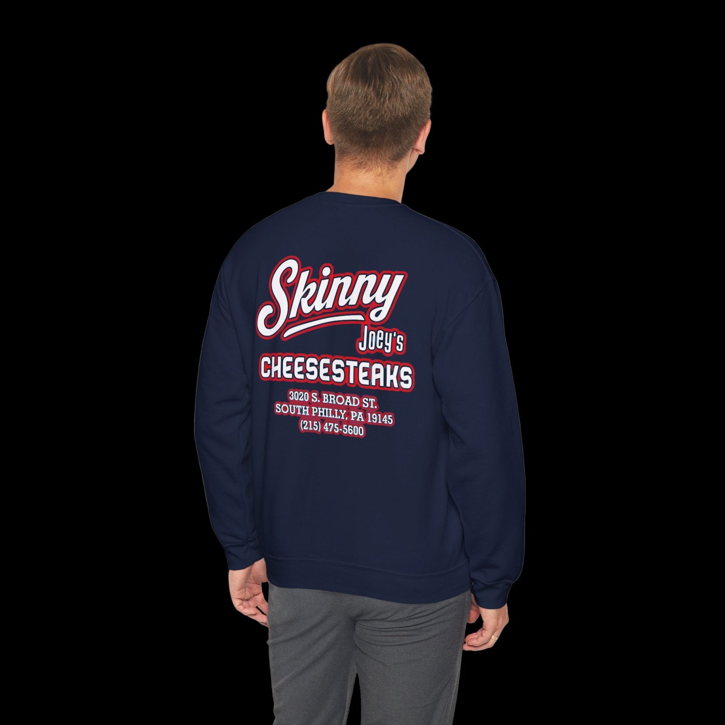 Navy blue sweatshirt with red and white text on the back, worn by a person.