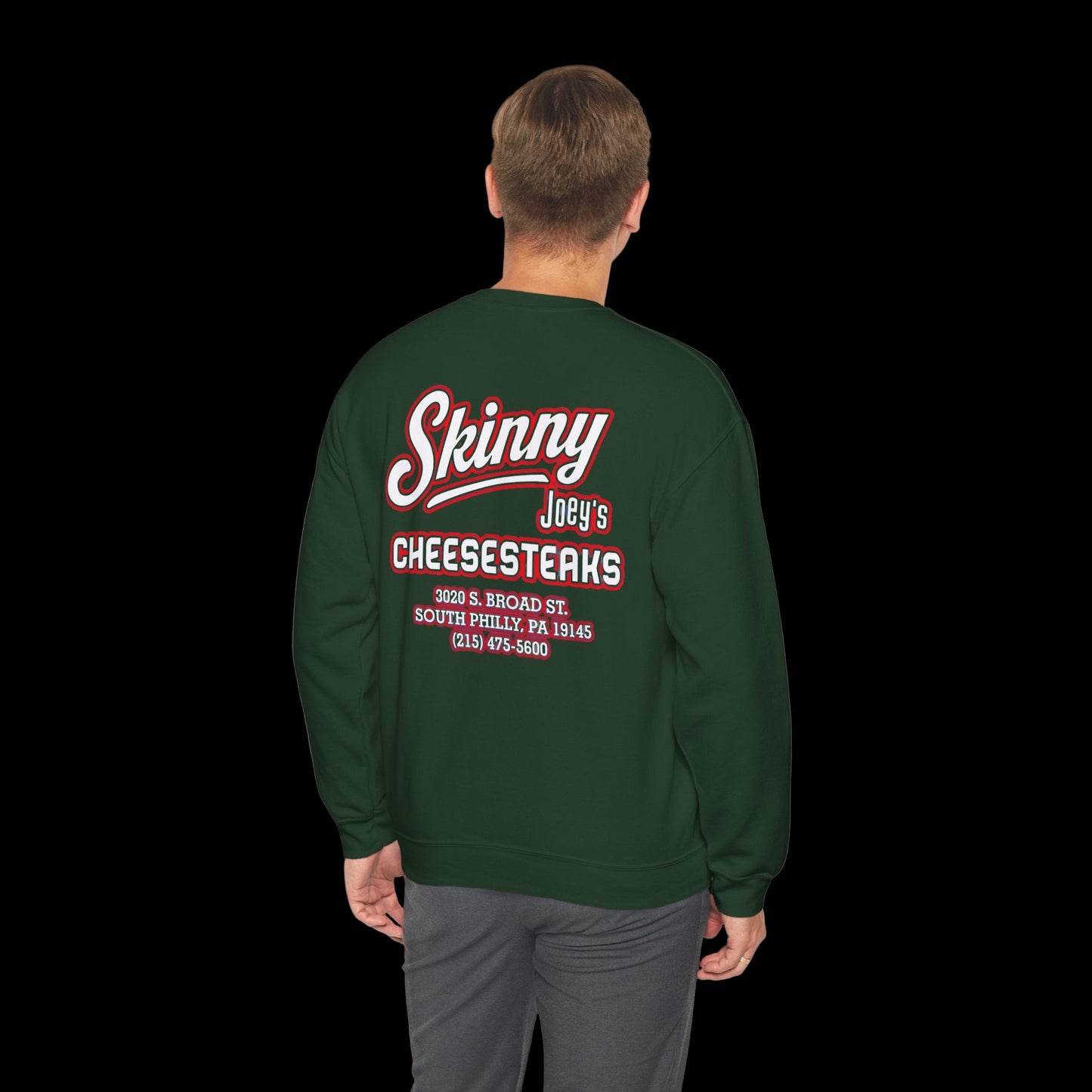 Green sweatshirt with red and white text on the back, worn by a person on a white background