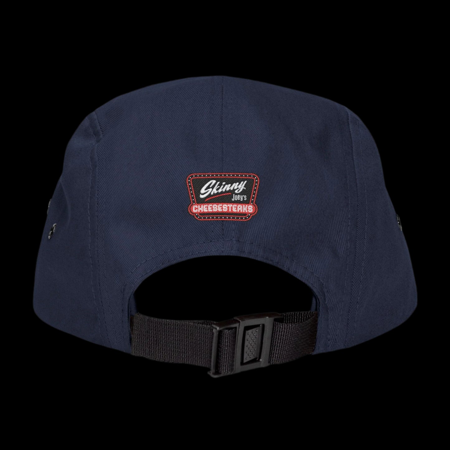 Navy blue cap with a logo on the back against a white background. Skinny Joey Merlino 5-panel hat featuring official Skinny Joey Merlino logo, perfect for fans of Skinny Joey Merlino, Skinny Joey’s Cheesesteaks, and The Skinny with Joey Merlino Podcast. This Skinny Joey Merlino cap blends South Philly street style with classic Skinny Joey Merlino fashion. A must-have for Joey Merlino supporters, real ones, and anyone loyal to Skinny Joey Merlino’s legacy