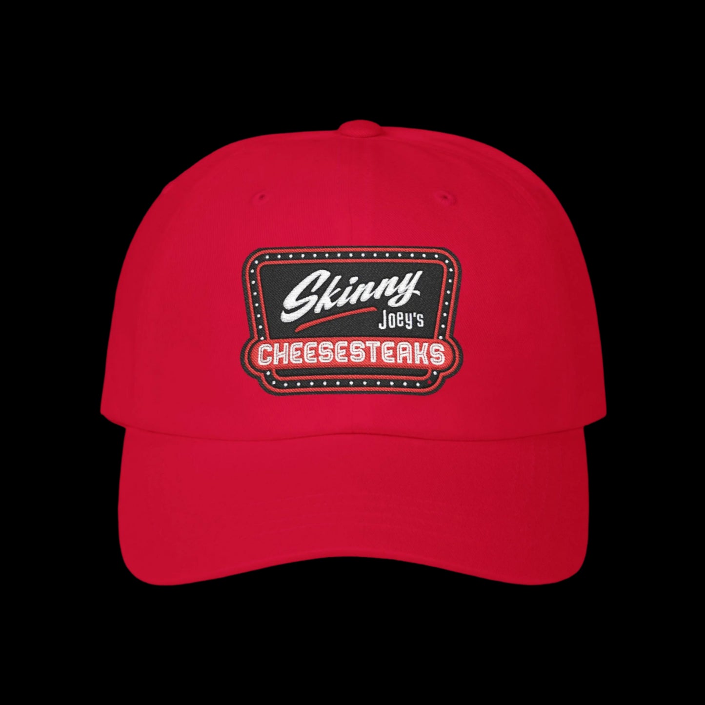 Red cap with 'Skinny Joey's Cheesesteaks' logo on a white background.Skinny Joey Merlino hat, Skinny Joey merch, Joey Merlino hat, Philly cheesesteak hat, Skinny Joey’s Cheesesteaks streetwear, Joey Merlino apparel, The Skinny Podcast hat, mob-inspired fashion, South Philly cap, Skinny Joey red logo hat.