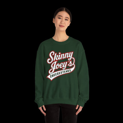 Person wearing a green sweatshirt with 'Skinny Joey's Cheesesteaks' text on a white background