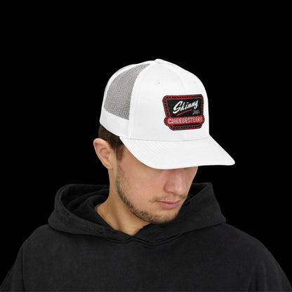 Man wearing a white trucker cap with a logo on a white background