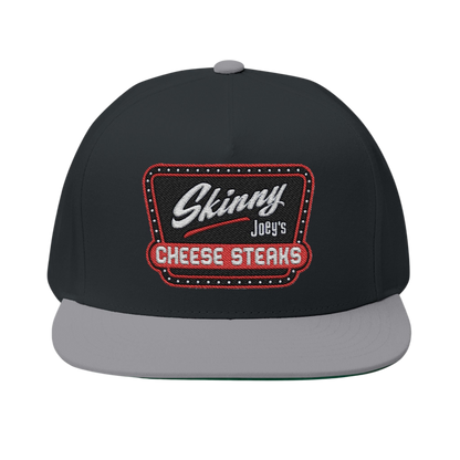 Black and gray cap with 'Skinny Joey's Cheese Steaks' logo on a white background