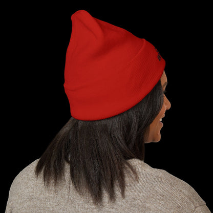 Person wearing a red beanie on a black background