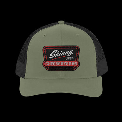 Green and black cap with 'Skinny Joey's Cheesesteaks' logo on a white background