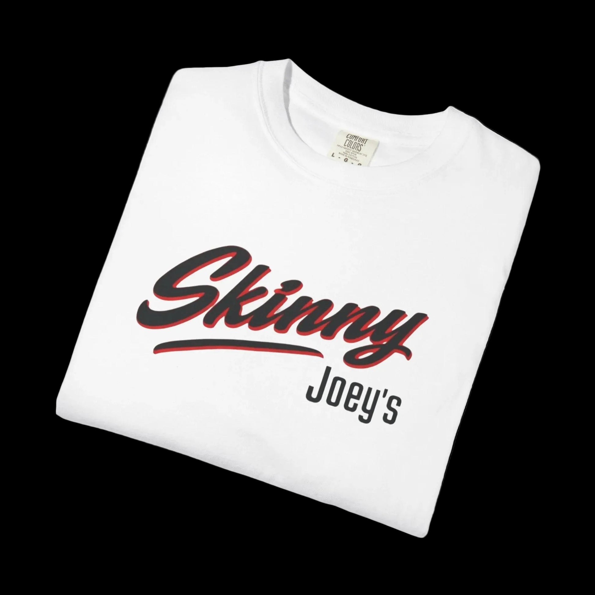 Folded white t-shirt with 'Skinny Joey's' text on a black background