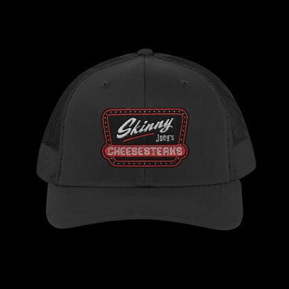 Black cap with 'Skinny Joey's Cheesesteaks' logo on a white background