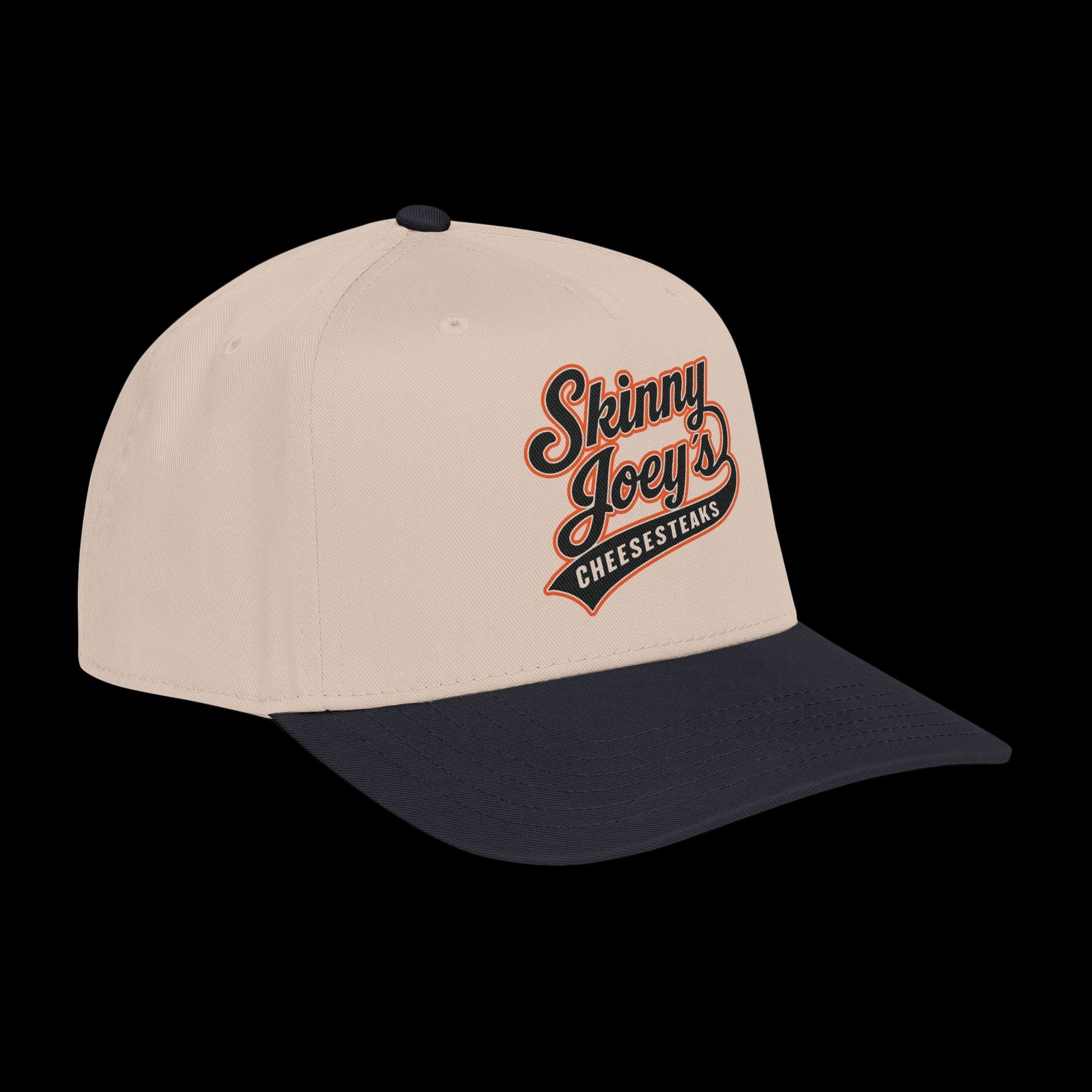 Beige and navy cap with 'Skinny Joey's Cheesesteaks' logo on a white background