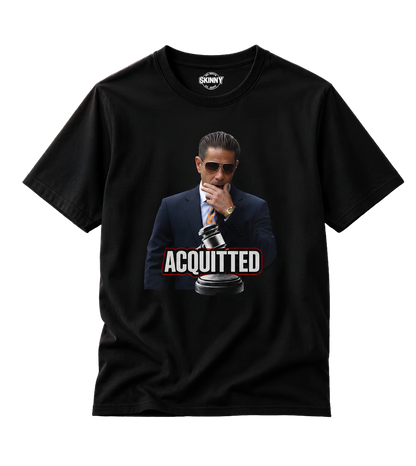 A black short-sleeve t-shirt with a graphic print of a man in a suit and sunglasses holding a gavel, with the word 'ACQUITTED' in bold white letters. The inner neck label shows the brand 'SCNYY'.