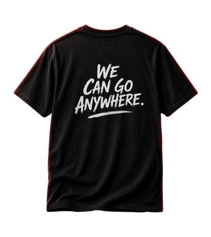 A black short-sleeve t-shirt shown from the back, featuring the phrase 'WE CAN GO ANYWHERE.' printed in a white brush-style font across the center.