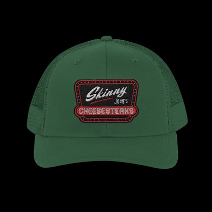 Green cap with embroidered logo on a white background