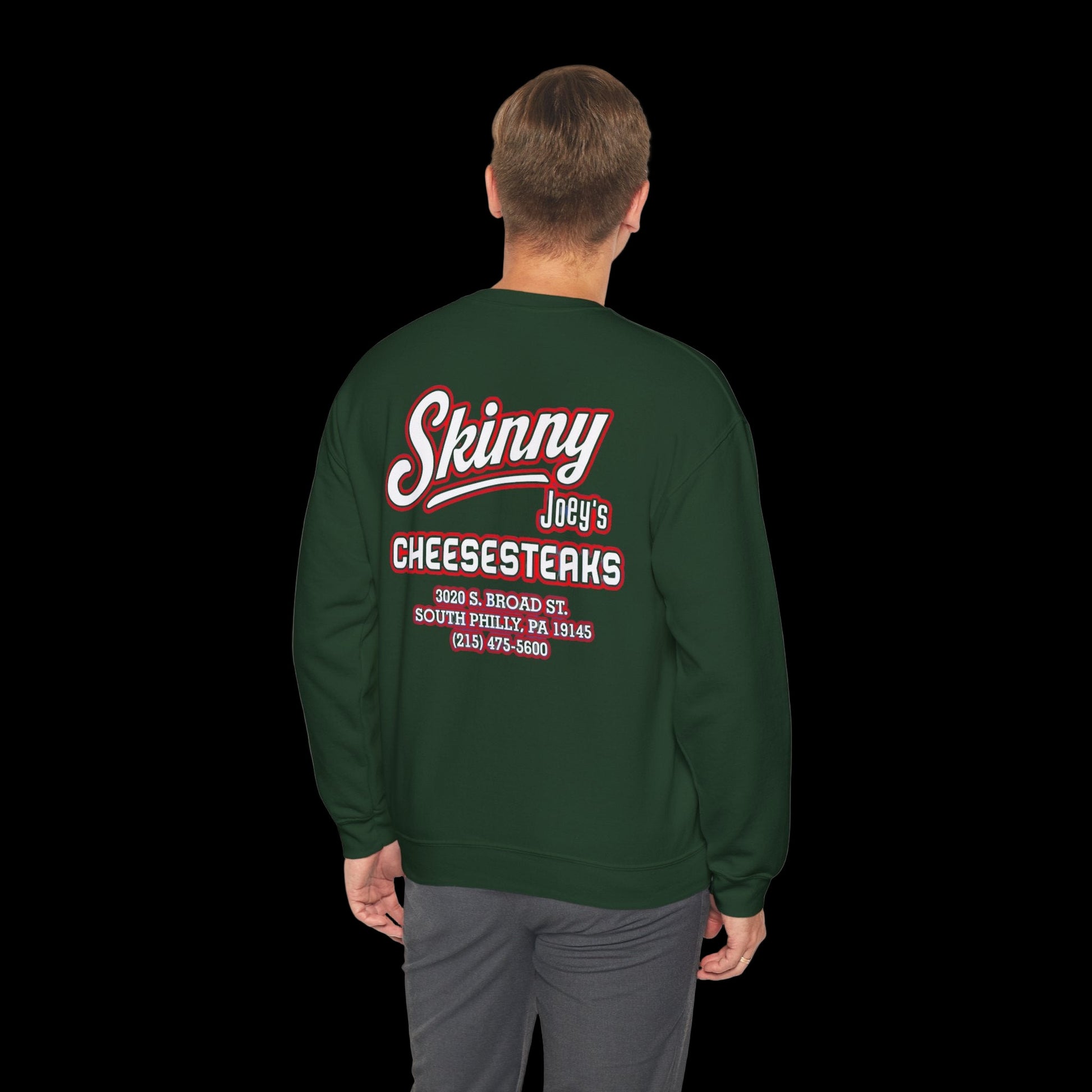 Green sweatshirt with red and white text on the back, worn by a person on a white background
