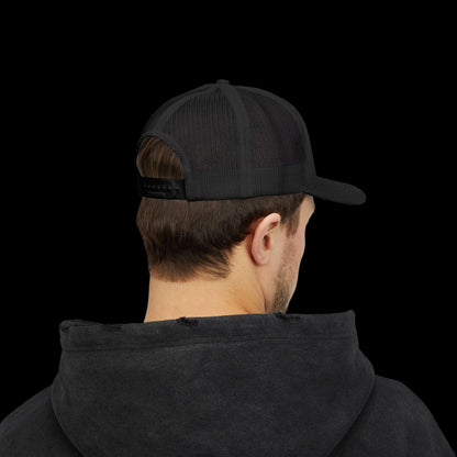 Person wearing a black cap and black hoodie on a white background