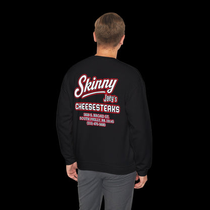 Black sweatshirt with 'Skinny Joey's Cheesesteaks' text on the back, worn by a person.
