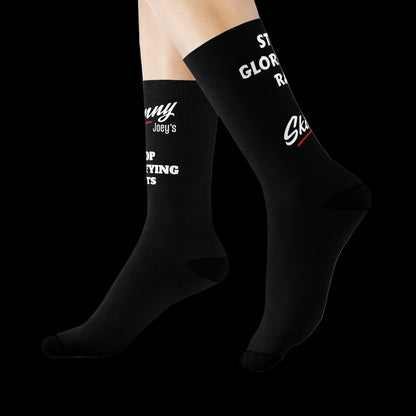 Black socks with white text worn by a person on a white background