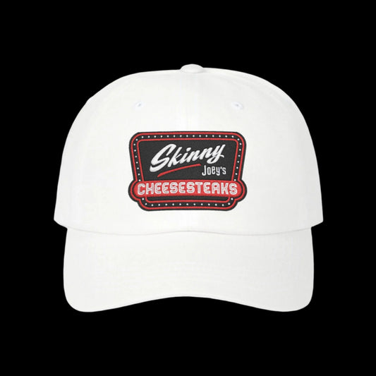 White cap with 'Skinny Joey's Cheesesteaks' logo on a black background. Skinny Joey Merlino hat, Skinny Joey merch, Joey Merlino hat, Philly cheesesteak hat, Skinny Joey’s Cheesesteaks streetwear, Joey Merlino apparel, The Skinny Podcast hat, mob-inspired fashion, South Philly cap, Skinny Joey red logo hat.
