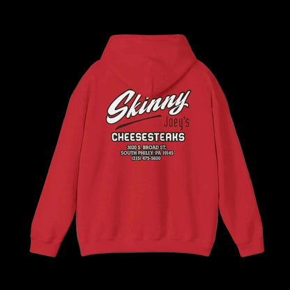 Red hoodie with 'Skinny Joey's Cheesesteaks' text on the back against a black background
