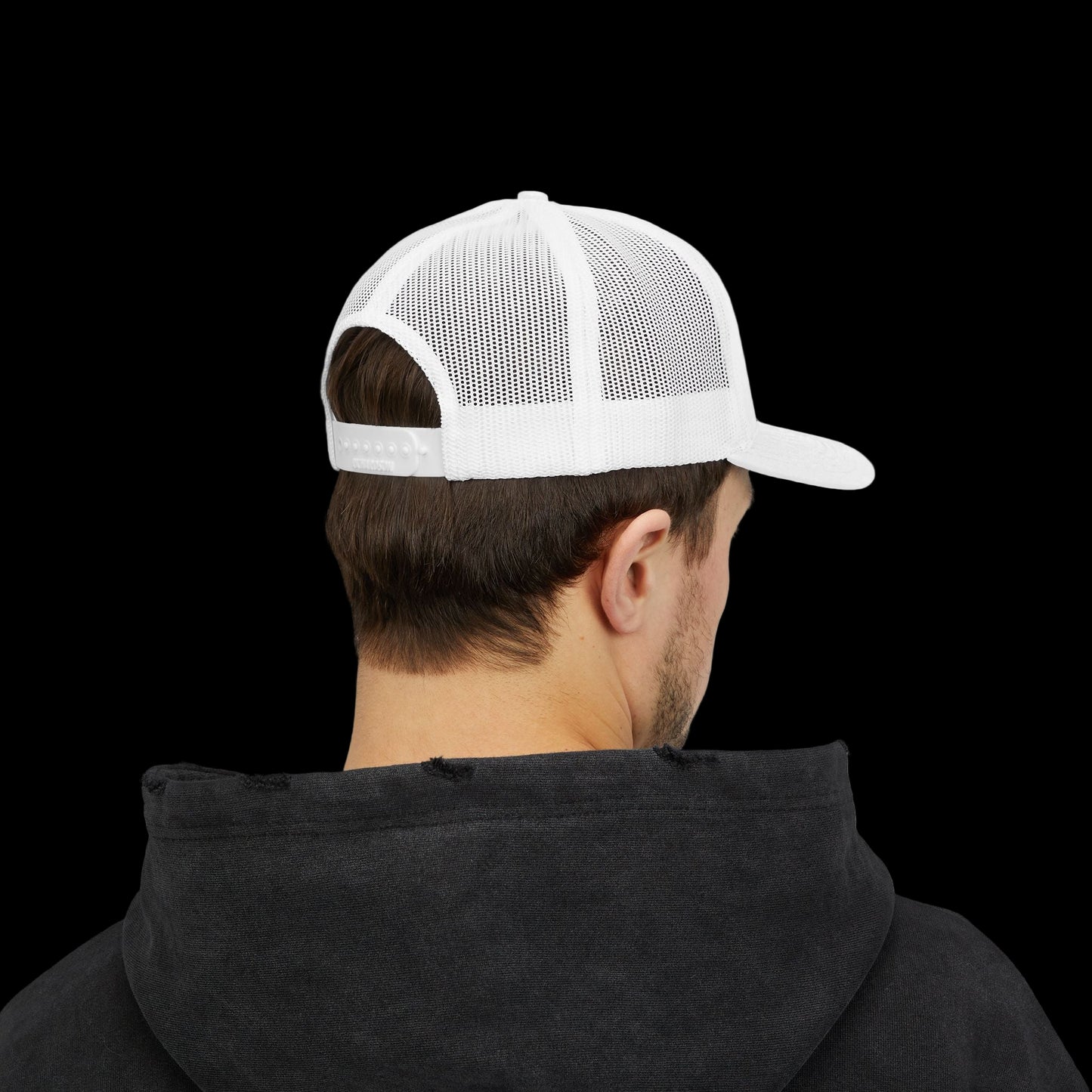 Person wearing a white mesh cap and black hoodie on a white background
