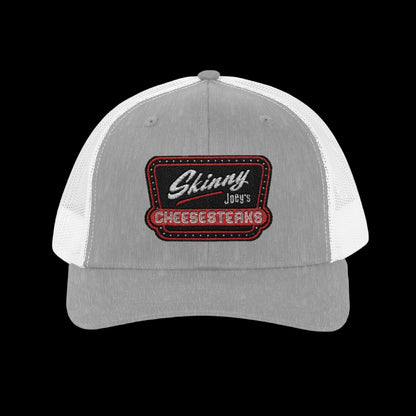 Gray and white cap with a red and black embroidered patch on a white background