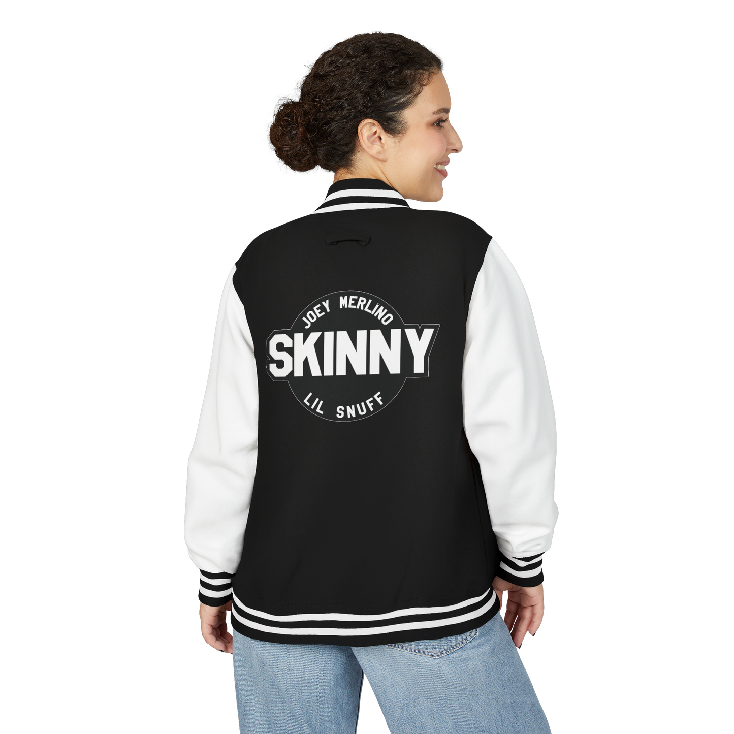 Person wearing a black and white varsity jacket with 'SKINNY' text on the back, standing against a white background.