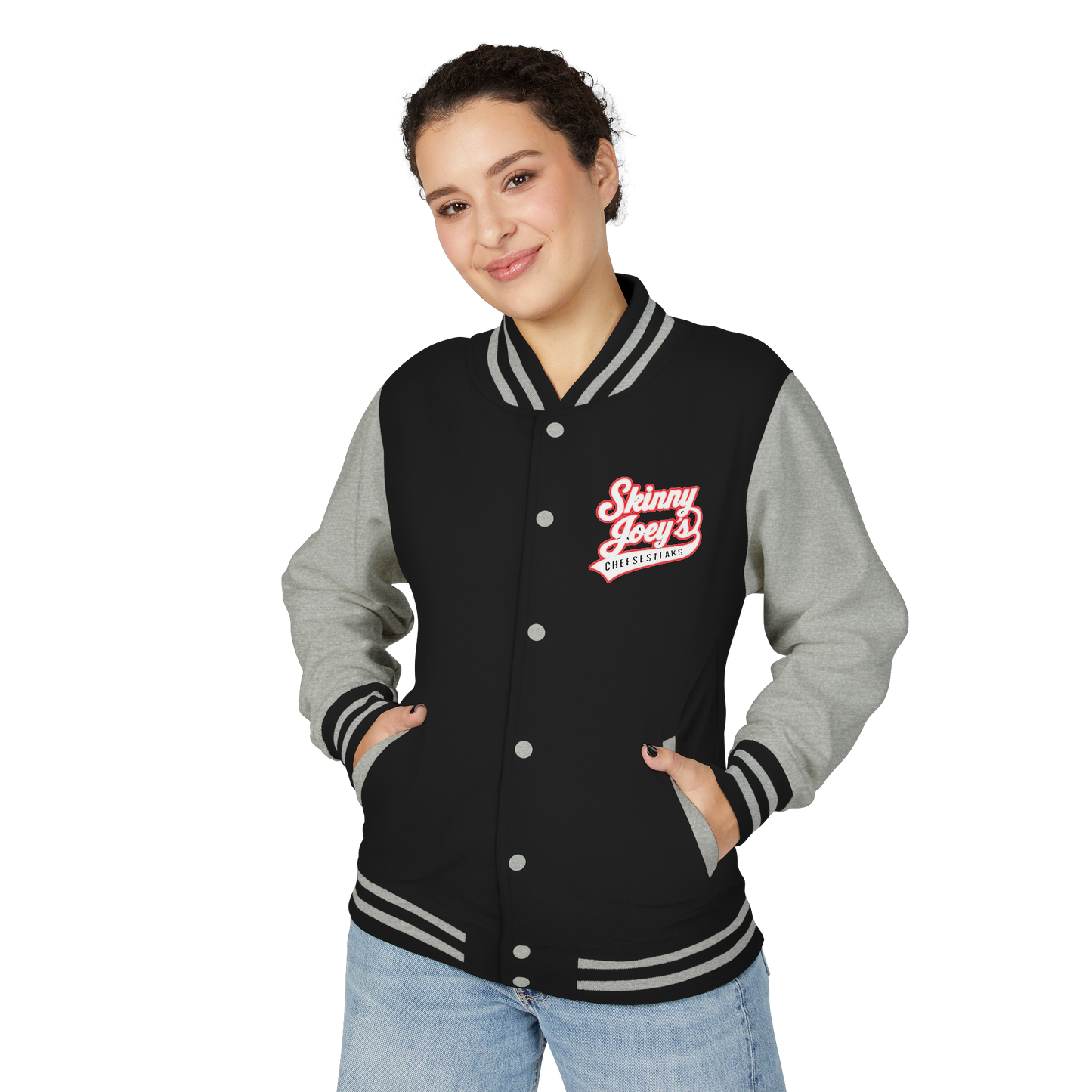 Person wearing a black and gray varsity jacket with a logo on a white background