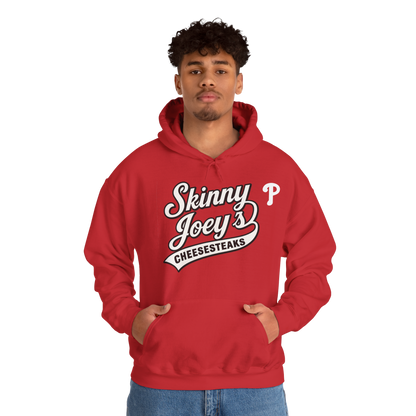 Person wearing a red hoodie with 'Skinny Joey's Cheesesteaks' text on a white background